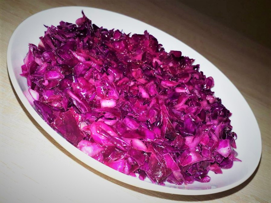 A table displaying a bowl of red cabbage.