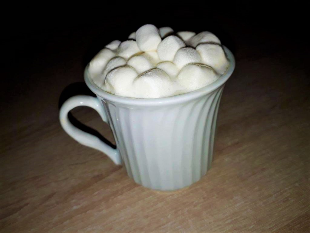 Hot chocolate with marshmallows served in a mug.