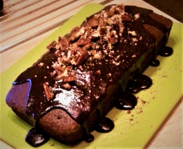 A chocolate cake on a green plate.
