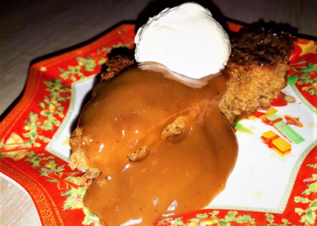A dessert featuring cake with caramel sauce and ice cream, from the Hotcakes Menu.